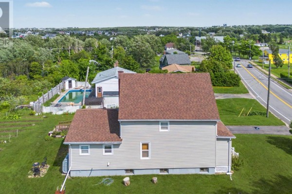 Aerial view of the property and surrounding neighborhood, including a road and distant houses. - 383 Kings Road, Dominion