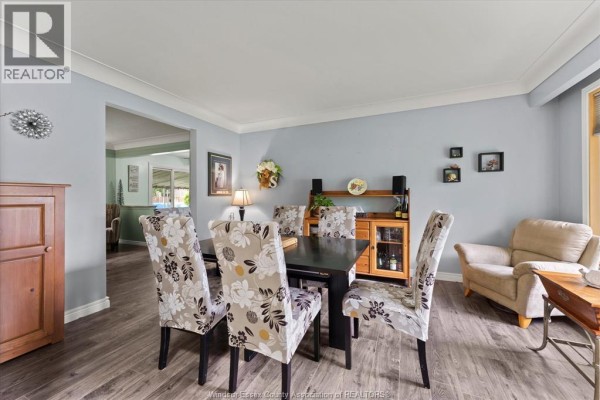 Dining room with wood table, floral chairs, and light blue walls. - 3831 Kathleen, Windsor