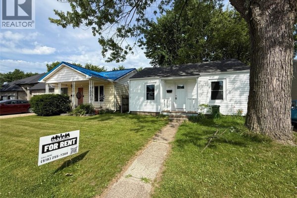 Street view of a white house with a 'For Rent' sign in the yard. - 3847 Matchett Road, Windsor