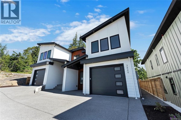 Close-up of duplex with scaffolding, showing window placements and construction materials. - 3849 Olympian Way, Colwood