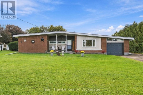 Front exterior of a brick ranch-style house with a modern design and attached garage. - 385 Lafontaine Road W, Tiny
