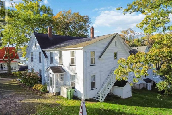 Rear exterior of the white building showing a staircase leading to an upper level. - 387 Church Hill Road, Sandy Cove