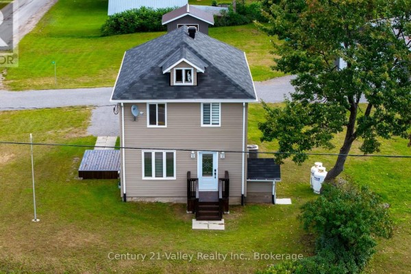 Small tan building with a metal roof and a single window on a gravel lot. - 387 Sell Road, North Algona Wilberforce