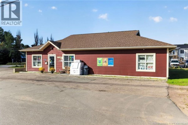 Side view of a commercial building with red siding and multiple windows. - 3881 Route 134, Shediac Bridge
