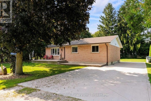Side view of a brick bungalow with a concrete driveway. - 38823 Vienna Street, Bluewater