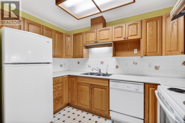 Dining room with wood hutch and table, leading to the kitchen. - 39 23580 Dewdney Trunk Road, Maple Ridge
