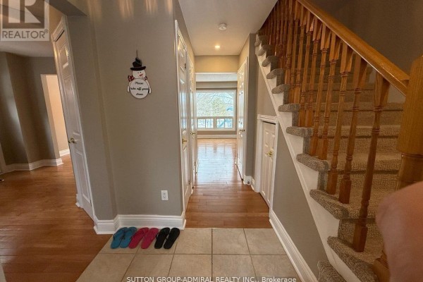 Hallway with wooden staircase, tile flooring, and gray walls - 39 April Gardens, Aurora