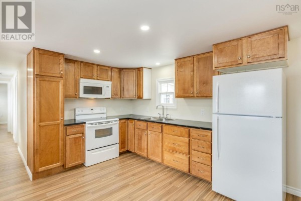 An empty room with light wood floors, cream-colored walls, and a set of white bi-fold closet doors. A white electrical panel is mounted on the wall. - 39 Beattie Drive, Windermere