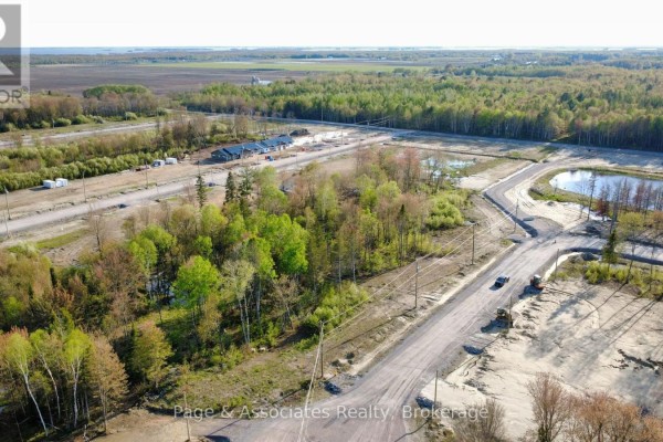 Aerial view of a new housing development with trees and roads. - 39 Brianne Court, West Nipissing
