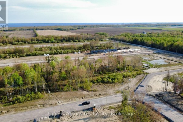 Aerial view of a new housing development with trees and roads. - 39 Brianne Court, West Nipissing