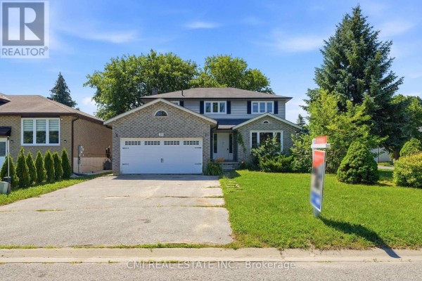 Two-storey brick and siding house with a two-car garage under a bright blue sky. - 39 Camrose Drive, Georgina