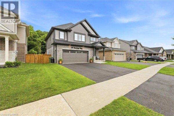 Exterior view of a grey and beige two-story house with a paved driveway and walkway in a suburban neighborhood. - 39 Dunning Way, St  Thomas