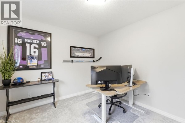 Office with framed jersey, hockey stick, and standing desk - 39 Dunning Way St  Thomas