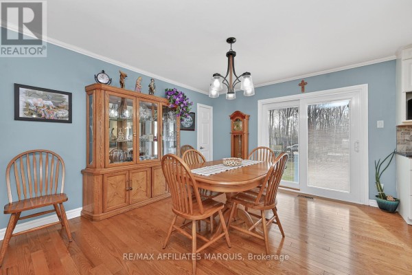 Wooden dining table and china cabinet in dining room - 39 Golf Club Road Rideau Lakes