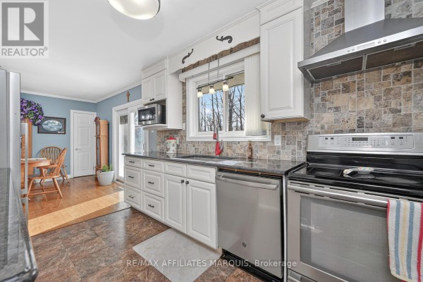 Kitchen with stainless steel appliances, granite countertops, and tile backsplash - 39 Golf Club Road Rideau Lakes