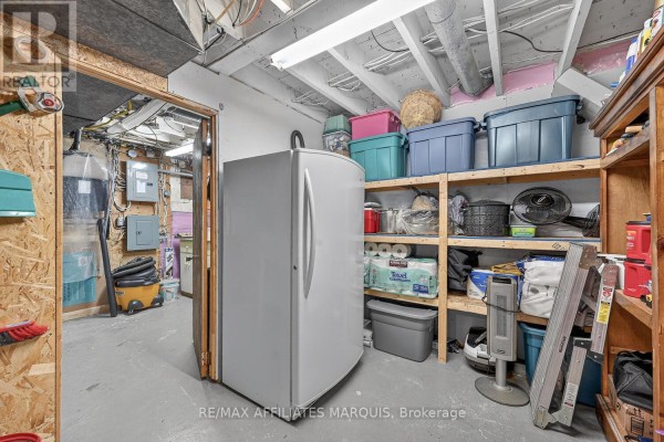 Basement with refrigerator, storage shelves, and utility items - 39 Golf Club Road Rideau Lakes