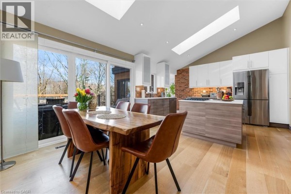 Bright kitchen with skylights, dining area, and modern cabinetry. - 39 Hilts Drive, Stoney Creek