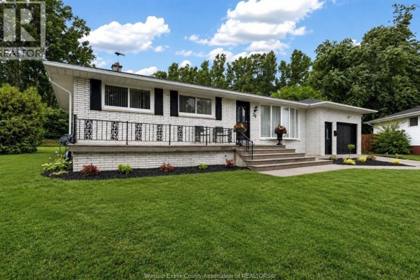 Close-up of the white brick exterior of a house with a front porch and landscaping. - 39 Johnson Avenue, Leamington