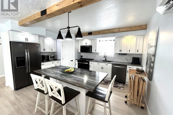 Spacious rec room with wood-paneled walls, outdoor furniture, a dartboard, and a barbecue grill. - 39 Main Road, Piccadilly