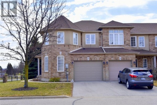 Basement family room with a sectional sofa, electric fireplace, and built-in shelving. - 39 Panabaker Drive Unit# 7, Ancaster