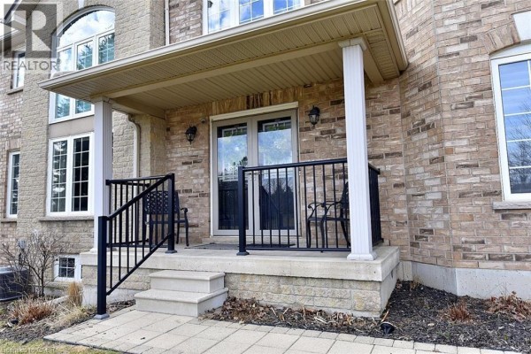 White kitchen with stainless steel appliances, including a French door refrigerator and a smooth-top stove. - 39 Panabaker Drive Unit# 7, Ancaster