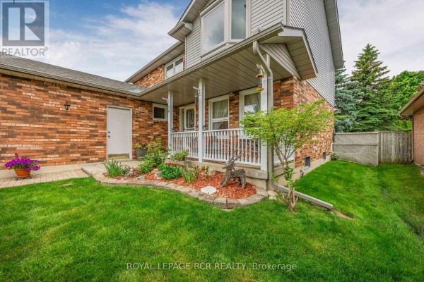 Front view of a two-story brick house with a double garage and clear sky - 39 Passmore Avenue, Orangeville
