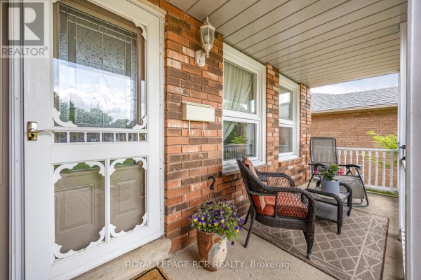 Side yard featuring a gate, greenery, and air conditioning unit - 39 Passmore Avenue, Orangeville