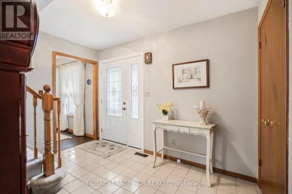Bright bedroom with a ceiling fan, wooden dresser, and neutral decor - 39 Passmore Avenue, Orangeville