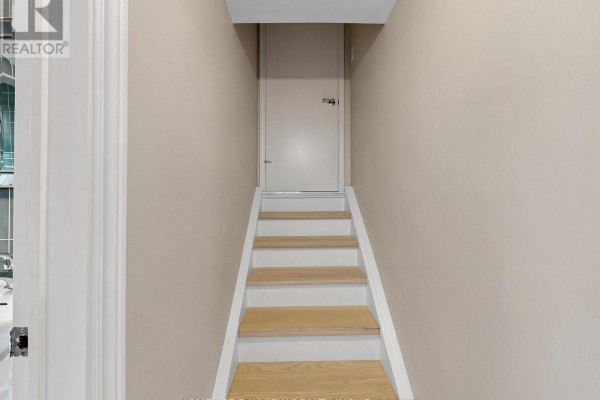 Basement with sofa, coffee table, single bed, dresser, and carpeted floor. - 39 Shenstone(basement) Road, Toronto