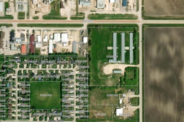 Aerial view of the Niverville area, highlighting residential streets, commercial buildings, and the large lot at 390 Main Street. - 390 Main Street, Niverville