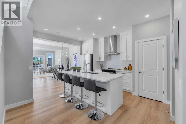 Bedroom with grey carpet, bi-fold closet doors, and large window with a rural view. - 390 South Shore Drive, Chestermere
