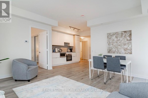 Living room with dining area, kitchen, seating, and city view. - 3907 - 28 Freeland St. Street, Toronto