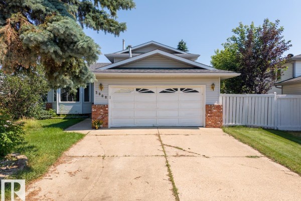 Front exterior view of a single-family home with a light siding and brick accents. - 3908 28 Av Nw, Edmonton
