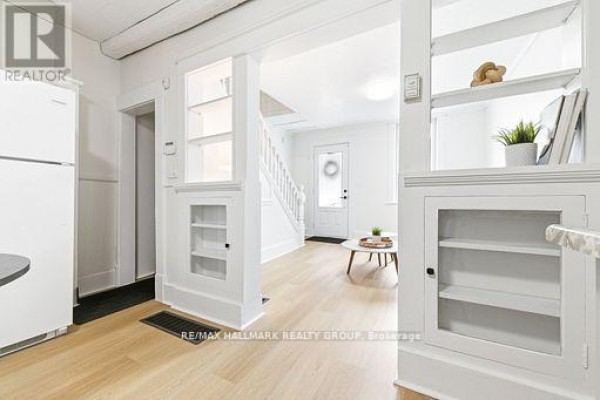 Bright living room with large window, door to outside, and modern decor. - 391 Murray Street, Pembroke