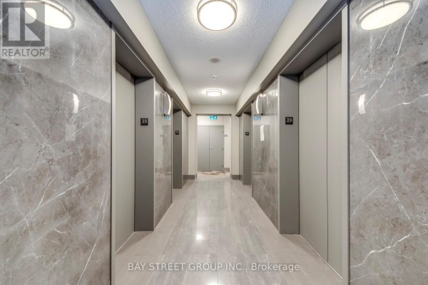 Entryway with mirrored closet doors and polished tile flooring - 3912 - 35 Mariner Terrace, Toronto