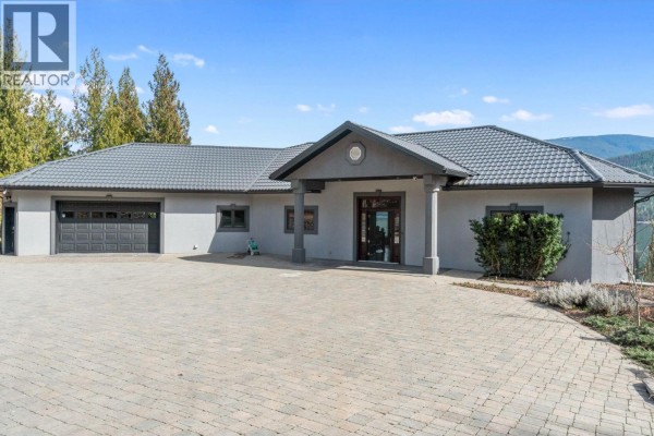 Large modern house on a forested hill overlooking a lake with a dock and boathouse. - 3918 Parri Road, Sorrento