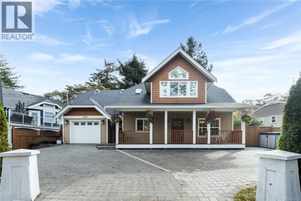 Wide view of the beige house exterior with a covered porch and a paved driveway. - 3919 Blenkinsop Rd, Saanich