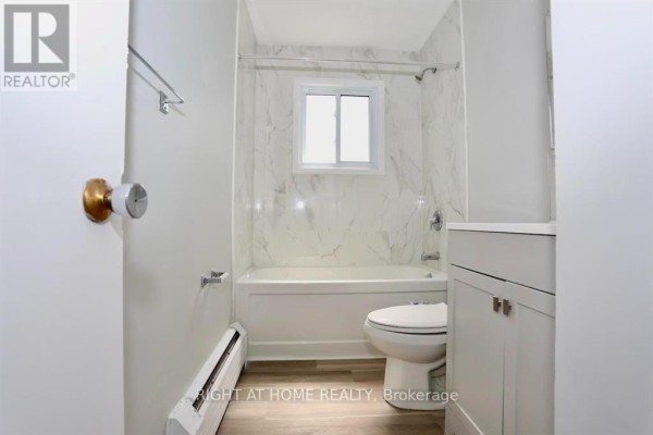 Second bathroom with marble walls, shower, and modern fixtures - 394 Thiel Street, London East