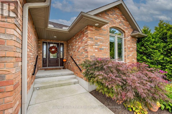 Front entrance with a brick facade, glass door, and steps leading to the walkway. - 395 3rd Street S, Hanover