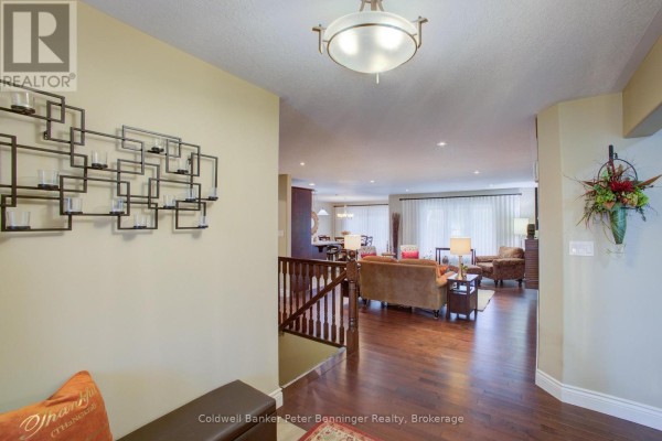 Interior foyer with dark hardwood floors, modern wall art, and an open view to the living room. - 395 3rd Street S, Hanover