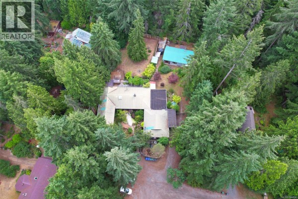 Aerial view of a sprawling home surrounded by mature evergreen trees on Gabriola Island. - 395 Lyngail Pl, Gabriola Island