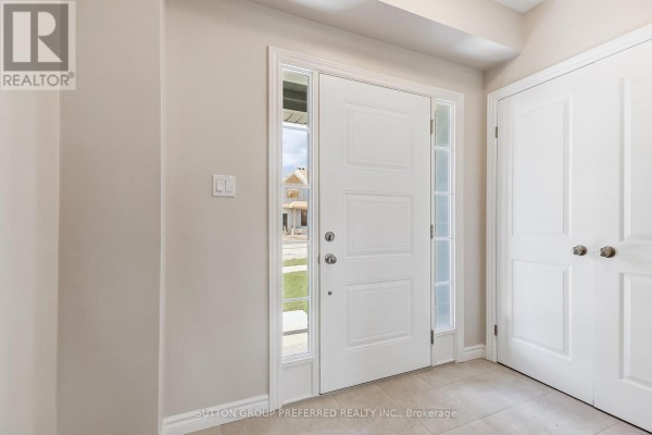 Powder room with a toilet, vanity with granite countertop, and a window. - 3956 Mia Avenue, London South