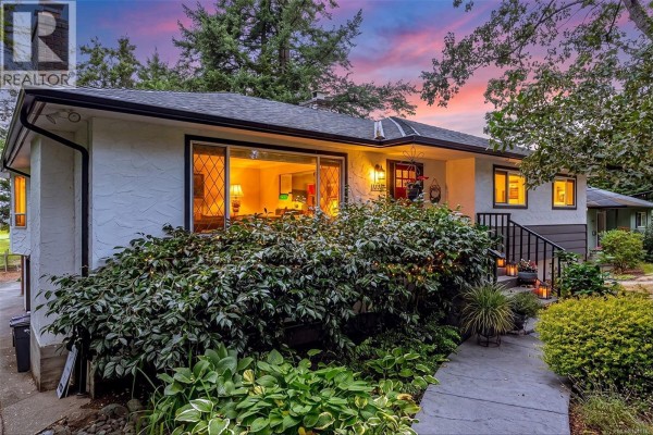 Aerial view of several houses surrounded by mature trees and greenery. - 3960 Cumberland Rd, Saanich