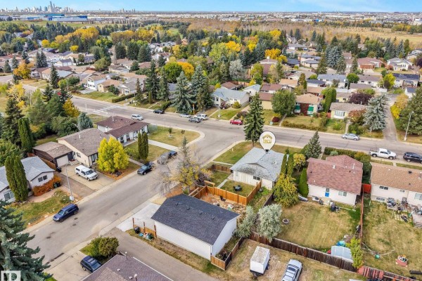 Distant aerial view of the property surrounded by mature trees and neighboring houses. - 3963 57 St Nw, Edmonton