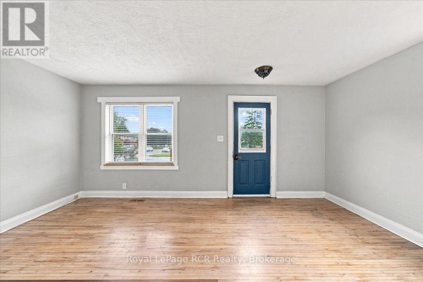 Aerial view showing the property boundaries outlined in red, with the house and driveway within. - 397 27th Street W, Owen Sound