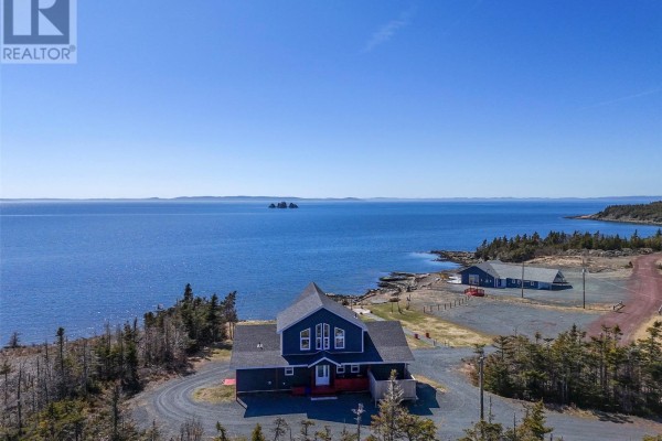 Dark blue building by the ocean with many windows, view of islands. - 397 Trinity South Highway, Whiteway