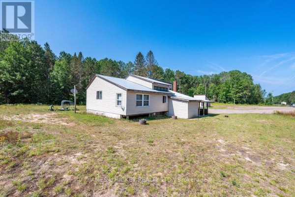 Side view of the house with light siding and a metal roof. - 39869 Highway 17 Highway, Head, Clara And Maria