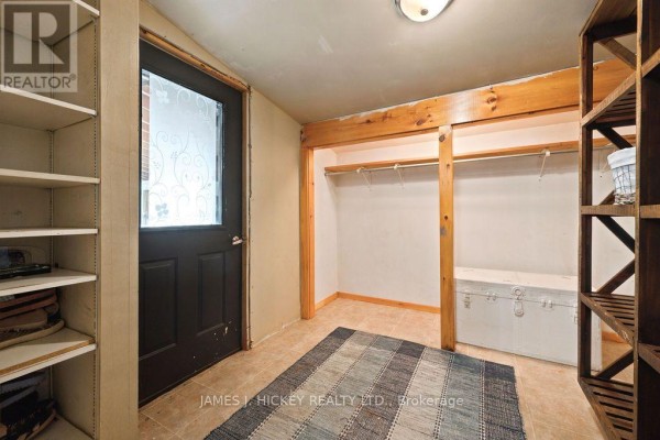 Interior view of a room with shelves, a black door with frosted glass, and a striped rug. - 39869 Highway 17 Highway, Head, Clara And Maria