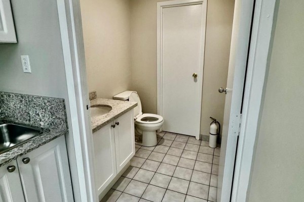 View of a small washroom with a toilet, vanity, and tiled floor. - 3a - 400 Creditstone Road W, Vaughan