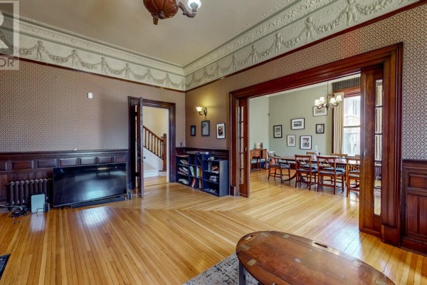 View of the living room from the opposite side, looking towards a dining room with a table and chairs. - 3a Forest Road, St  John S